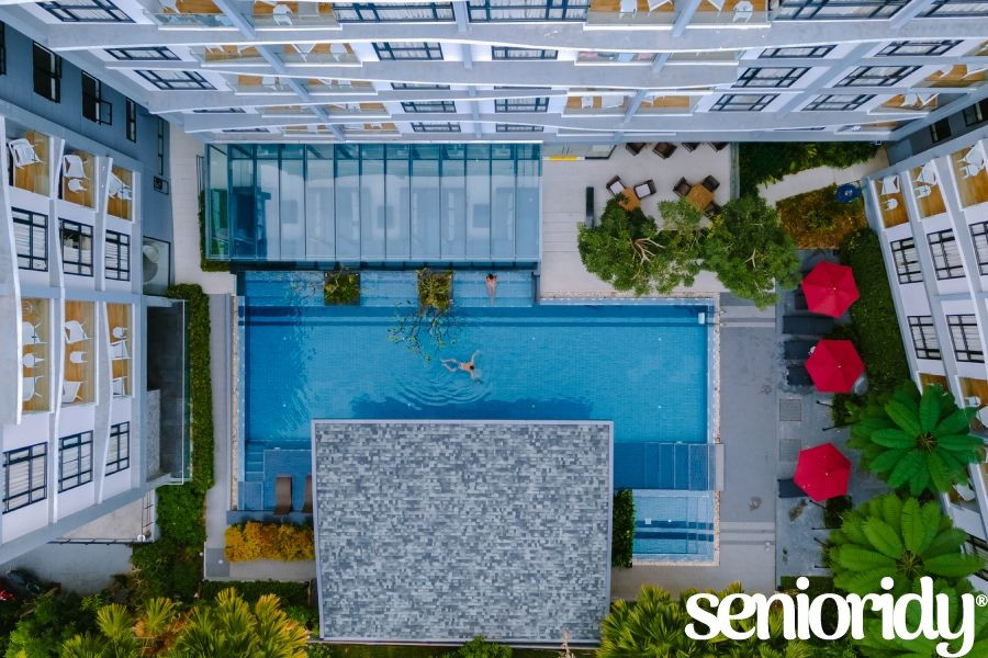 drone-view-from-above-at-swimming-pool-couple-on-senior-community