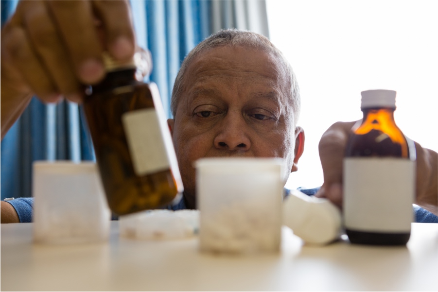 senior-man-taking-medicines-from-the-shelf.jpg