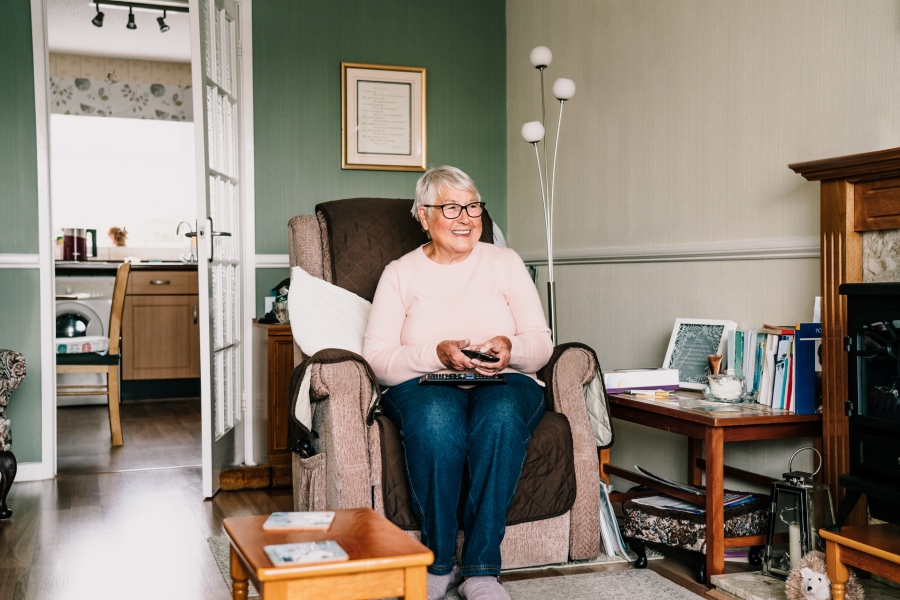 smiling-senior-woman-watching-tv-in-her-home.jpg
